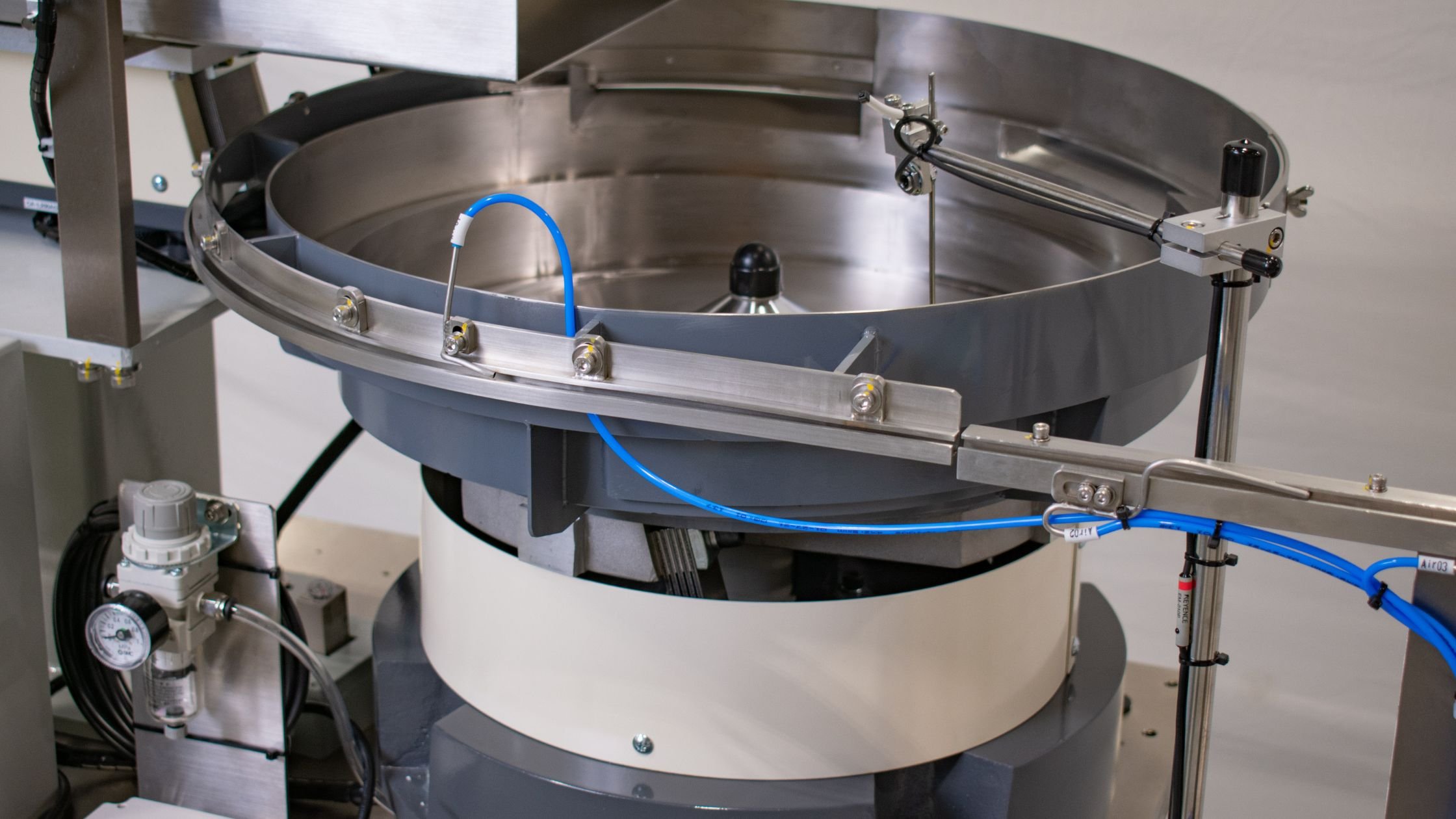 Image showcasing Plastic Cap Feeding by Bellco Feeders Boosts Productivity